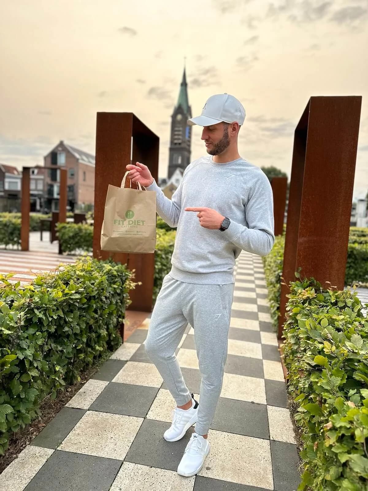 Man with a paper FitDiet order bag